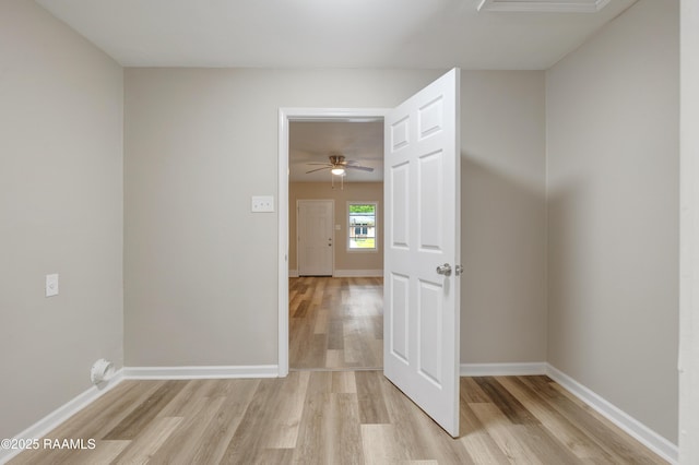 interior space with baseboards and light wood-style flooring