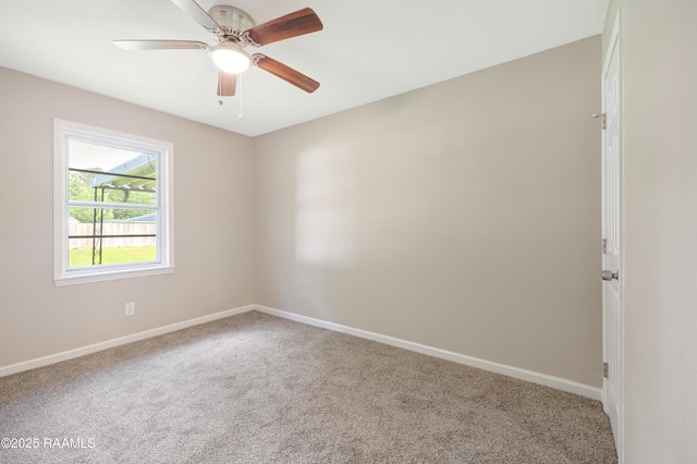 spare room with baseboards, a ceiling fan, and carpet