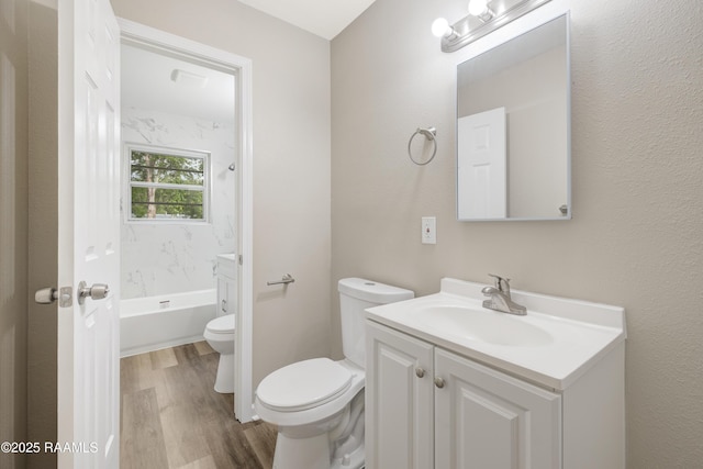 full bath featuring vanity, wood finished floors, and toilet