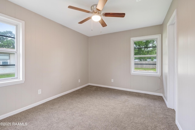 unfurnished room featuring baseboards, carpet, and a ceiling fan