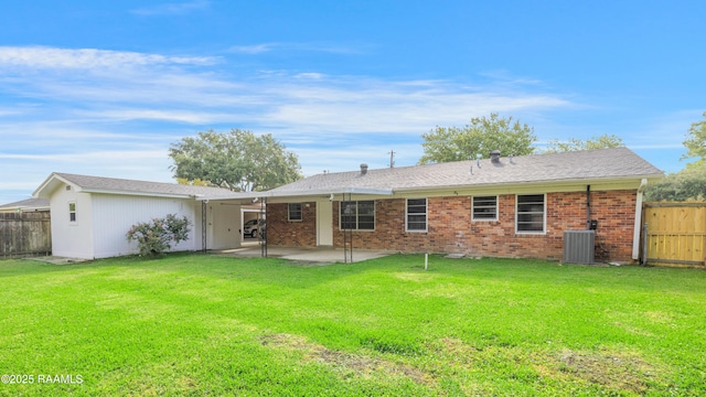 back of house with cooling unit, a fenced backyard, brick siding, a patio area, and a lawn
