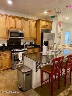 701 W Taft St Unit 7, Lafayette, LA 70503 - kitchen with appliances with stainless steel finishes, a kitchen breakfast bar, dark countertops, and recessed lighting