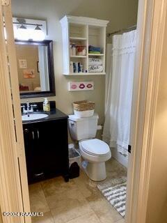 701 W Taft St Unit 7, Lafayette, LA 70503 - bathroom featuring vanity, toilet, a shower with curtain, and tile patterned flooring