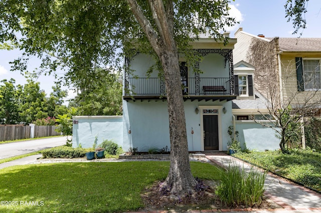 211 Ursuline St, Lafayette, LA 70506 - view of front of house featuring a balcony and stucco siding