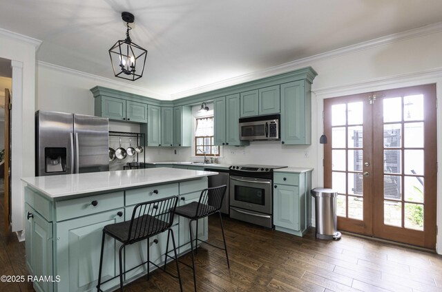 211 Ursuline St, Lafayette, LA 70506 - kitchen with stainless steel appliances, french doors, light countertops, crown molding, and dark wood-type flooring