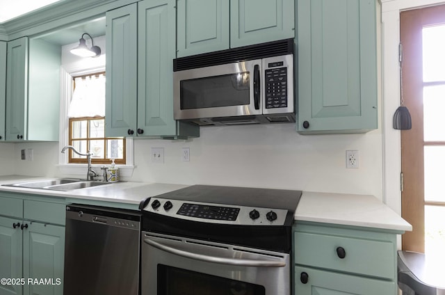 211 Ursuline St, Lafayette, LA 70506 - kitchen featuring appliances with stainless steel finishes, light countertops, and green cabinetry
