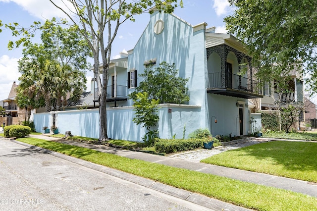 211 Ursuline St, Lafayette, LA 70506 - view of front of home featuring stucco siding and a balcony