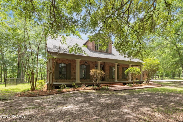 110 Interlaken Dr, New Iberia, LA 70563 - view of front of house featuring a porch, brick siding, and fence