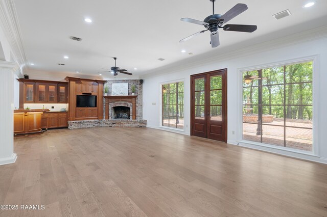 110 Interlaken Dr, New Iberia, LA 70563 - unfurnished living room with a ceiling fan, ornamental molding, a fireplace, light wood finished floors, and recessed lighting