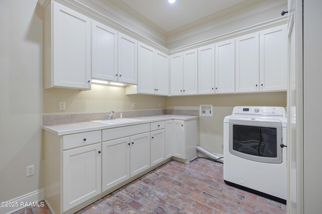 110 Interlaken Dr, New Iberia, LA 70563 - laundry room featuring washer / dryer, cabinet space, brick flooring, crown molding, and baseboards