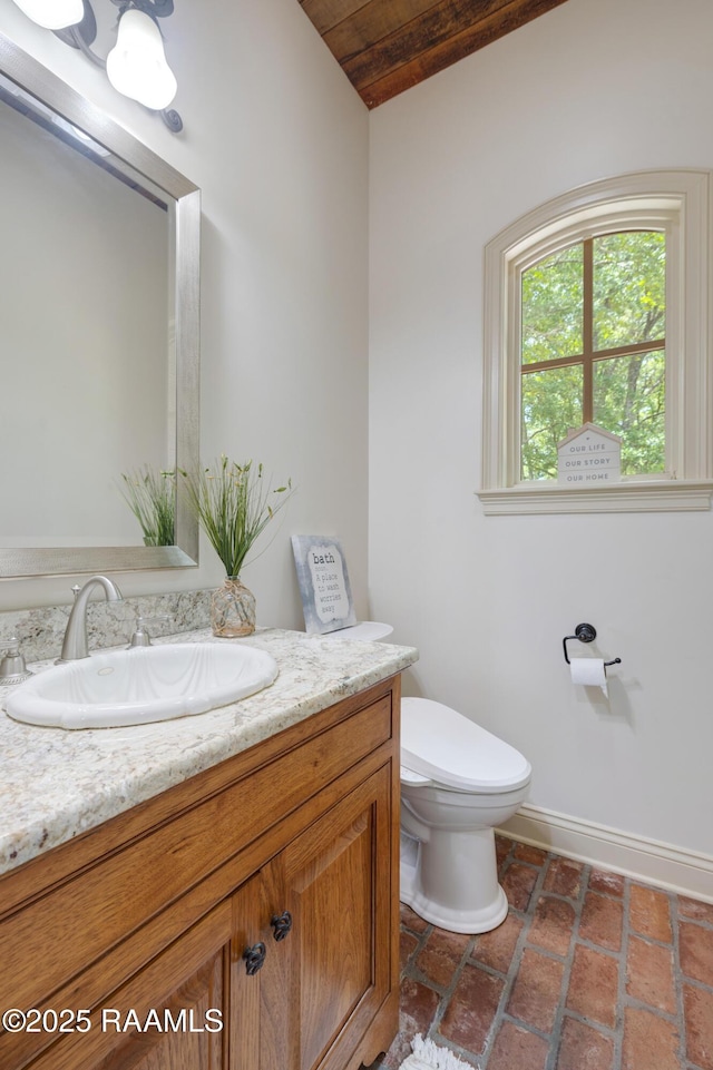 110 Interlaken Dr, New Iberia, LA 70563 - bathroom with vanity, toilet, baseboards, and wooden ceiling
