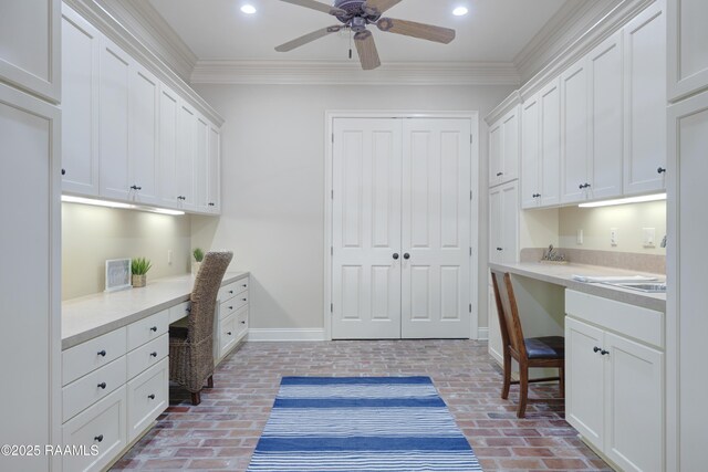 110 Interlaken Dr, New Iberia, LA 70563 - office with built in study area, brick floors, baseboards, crown molding, and ceiling fan