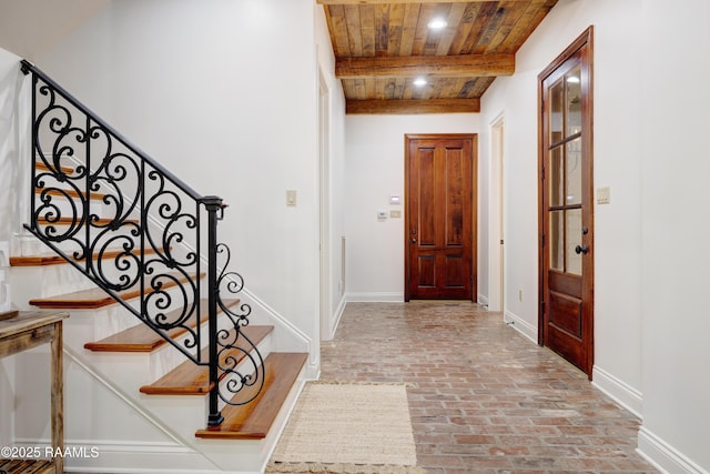 110 Interlaken Dr, New Iberia, LA 70563 - entrance foyer with wood ceiling, brick flooring, stairway, beamed ceiling, and baseboards