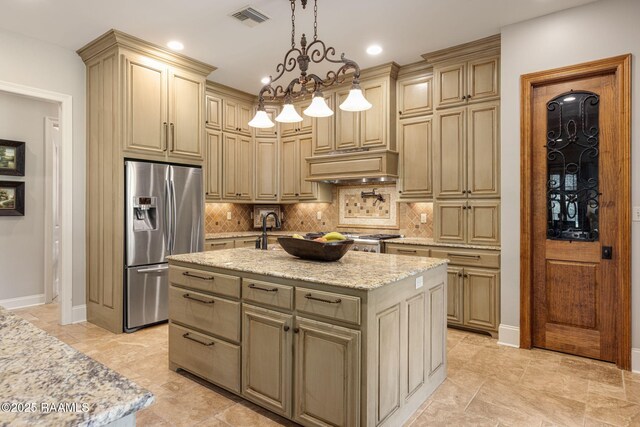 kitchen with visible vents, tasteful backsplash, light stone countertops, a notable chandelier, and stainless steel fridge