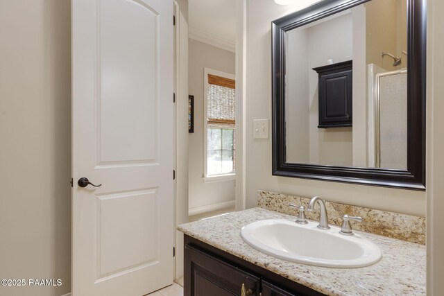 bathroom featuring crown molding and vanity
