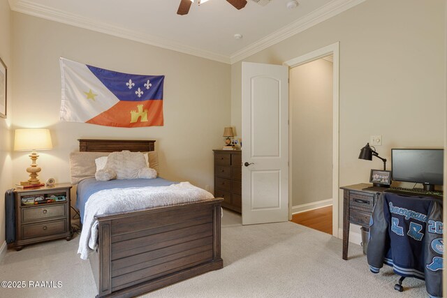 carpeted bedroom with a ceiling fan, baseboards, and ornamental molding