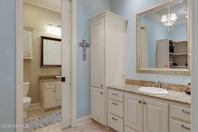 bathroom featuring vanity, ornamental molding, toilet, and a notable chandelier