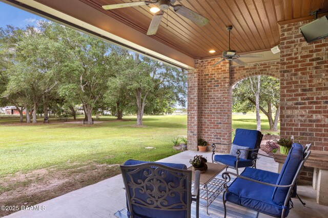 view of patio with ceiling fan and an outdoor living space