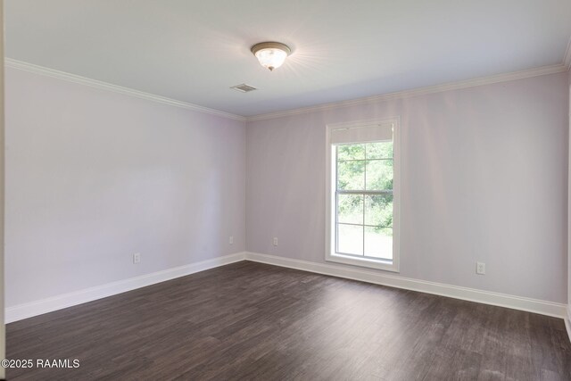 spare room with baseboards, dark wood-style flooring, crown molding, and visible vents
