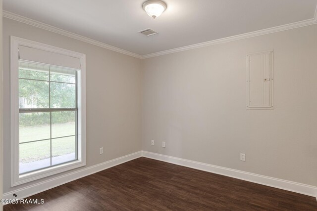 empty room featuring baseboards, ornamental molding, visible vents, and dark wood-type flooring