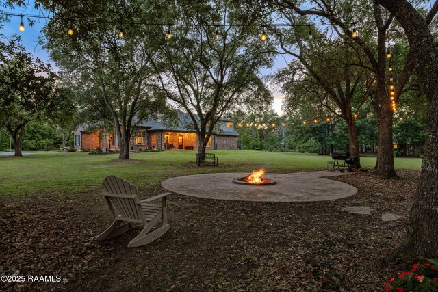 view of yard featuring an outdoor fire pit and a patio area