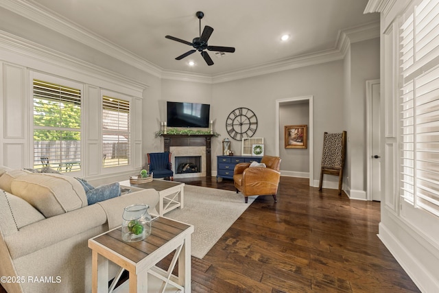 living area with ornamental molding, a ceiling fan, recessed lighting, a fireplace with flush hearth, and dark wood-style floors