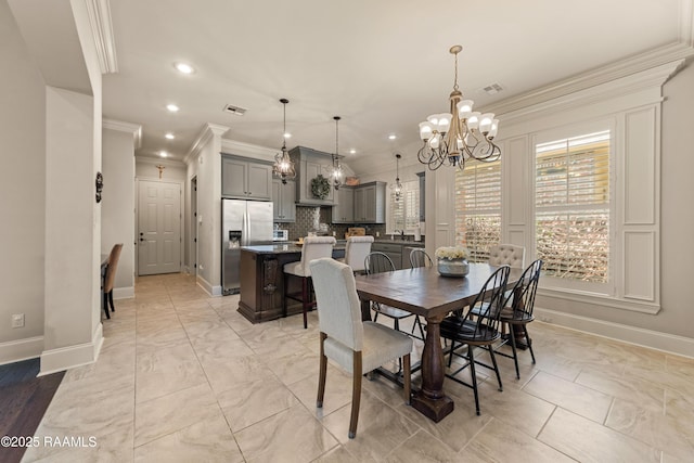 dining space featuring an inviting chandelier, marble finish floor, recessed lighting, baseboards, and ornamental molding