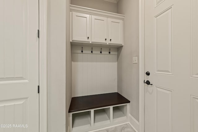 mudroom featuring baseboards and marble finish floor