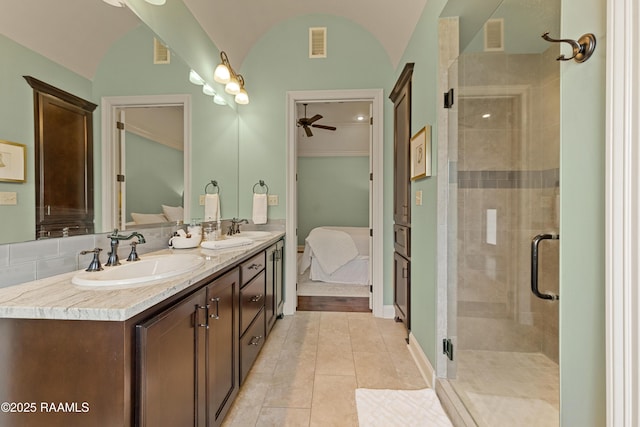 bathroom with a sink, ensuite bathroom, a ceiling fan, and visible vents