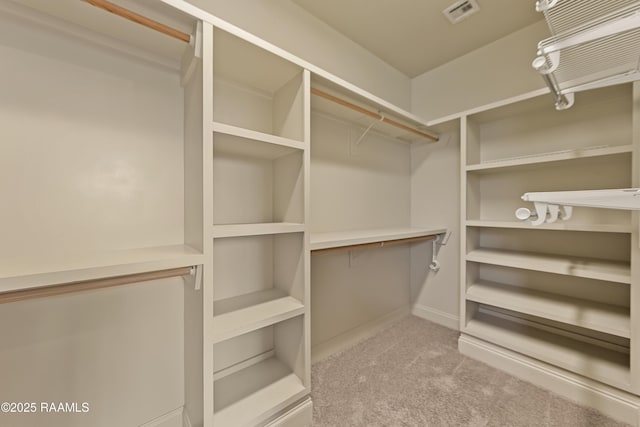 spacious closet with carpet and visible vents
