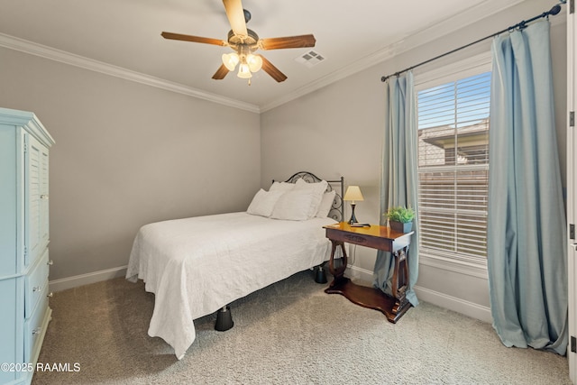 carpeted bedroom with visible vents, baseboards, crown molding, and ceiling fan