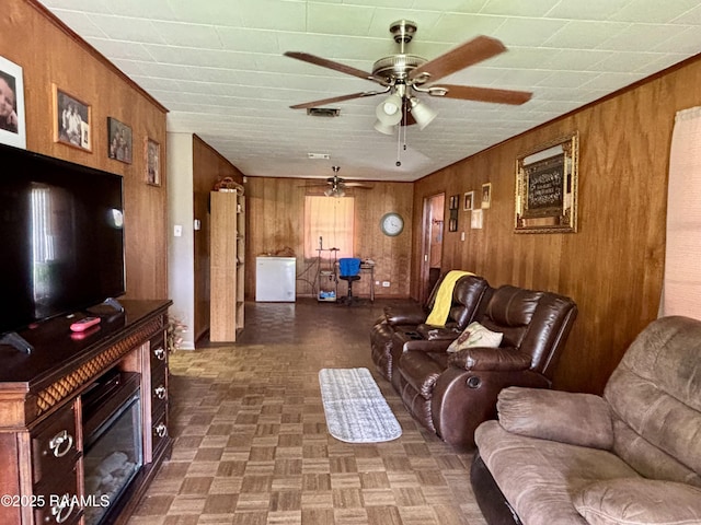 living room with wooden walls and a ceiling fan