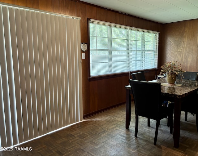 dining room featuring wooden walls