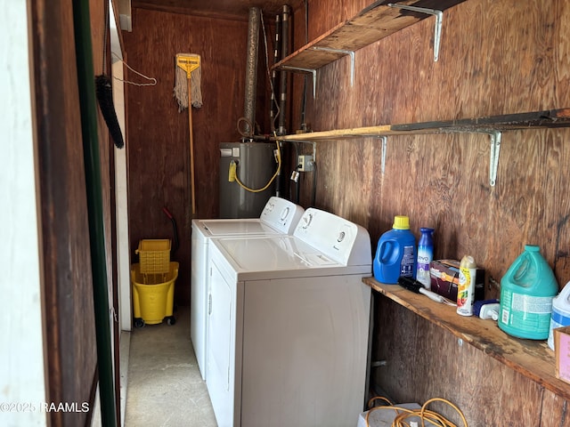 laundry room featuring washing machine and clothes dryer, laundry area, and water heater