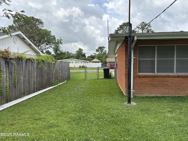 view of yard with fence and a gate