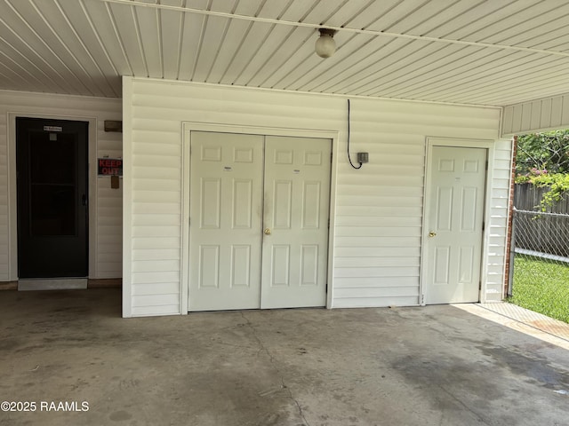 entrance to property featuring fence