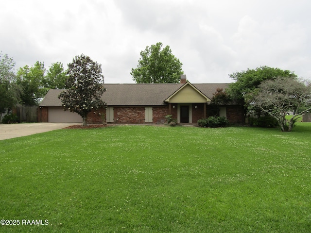 ranch-style house with a chimney, a front yard, concrete driveway, an attached garage, and a shingled roof