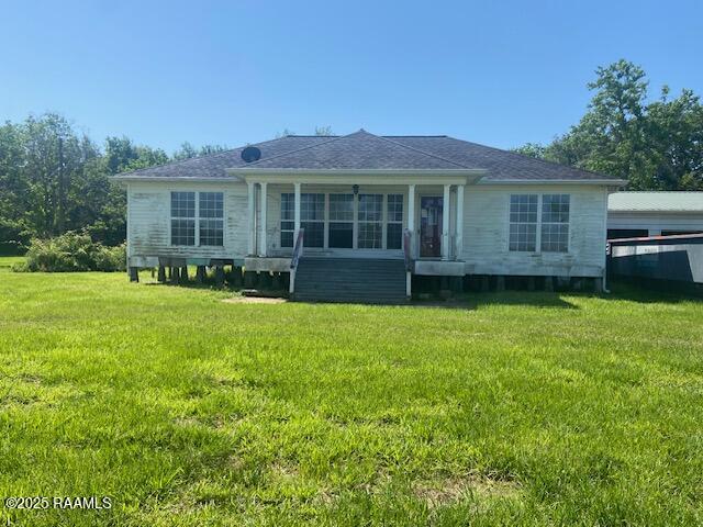 16224 Saint Elmo Rd, Erath, LA 70533 - rear view of property featuring a lawn and a sunroom