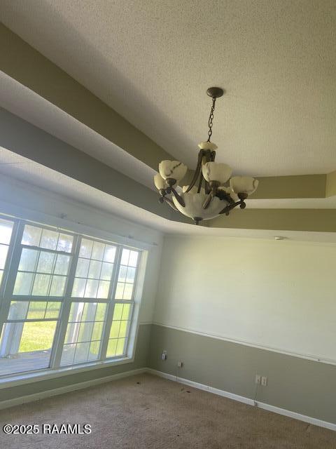 16224 Saint Elmo Rd, Erath, LA 70533 - carpeted spare room with a textured ceiling, a chandelier, and baseboards