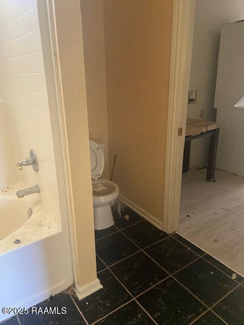 16224 Saint Elmo Rd, Erath, LA 70533 - full bath with a tub, tile patterned flooring, and toilet