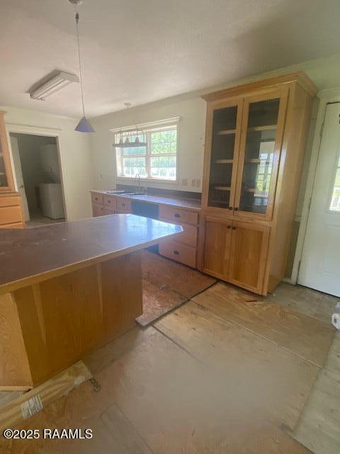 16224 Saint Elmo Rd, Erath, LA 70533 - kitchen featuring a sink, hanging light fixtures, and glass insert cabinets