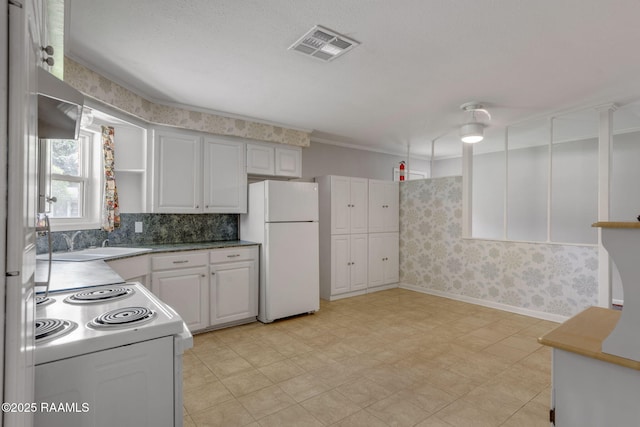 kitchen featuring visible vents, open shelves, white appliances, baseboards, and white cabinetry