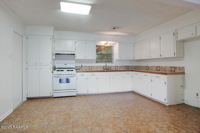 kitchen with white cabinetry, a textured ceiling, white gas range oven, and a sink