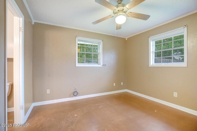 empty room featuring baseboards, ornamental molding, concrete flooring, and ceiling fan