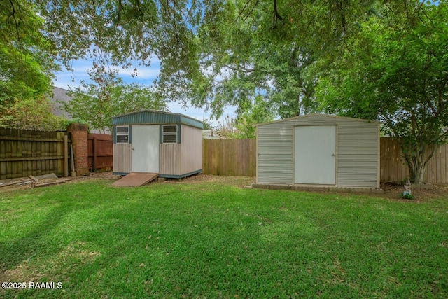 view of yard featuring an outdoor structure, a fenced backyard, and a storage unit