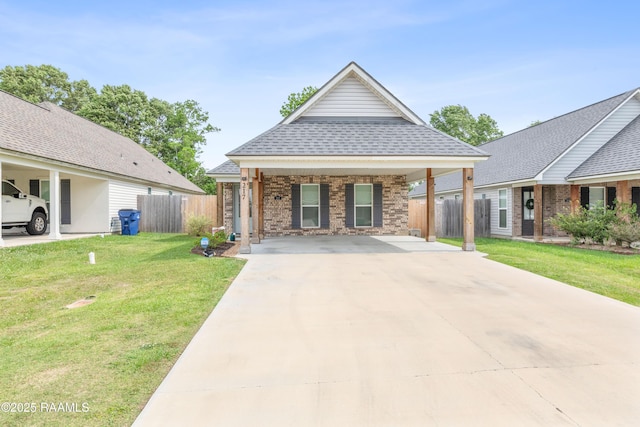 view of front of property with a front lawn, fence, roof with shingles, brick siding, and concrete driveway