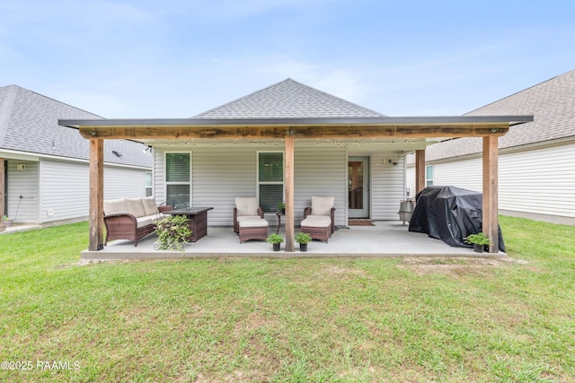 rear view of house featuring an outdoor hangout area, a patio, a shingled roof, and a lawn