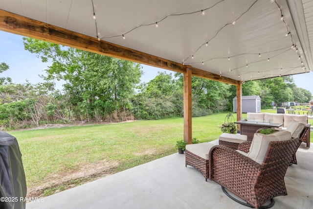 view of patio featuring an outdoor structure, an outdoor living space, and a shed