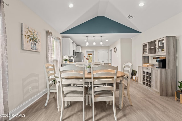 dining area featuring visible vents, lofted ceiling, baseboards, recessed lighting, and light wood finished floors