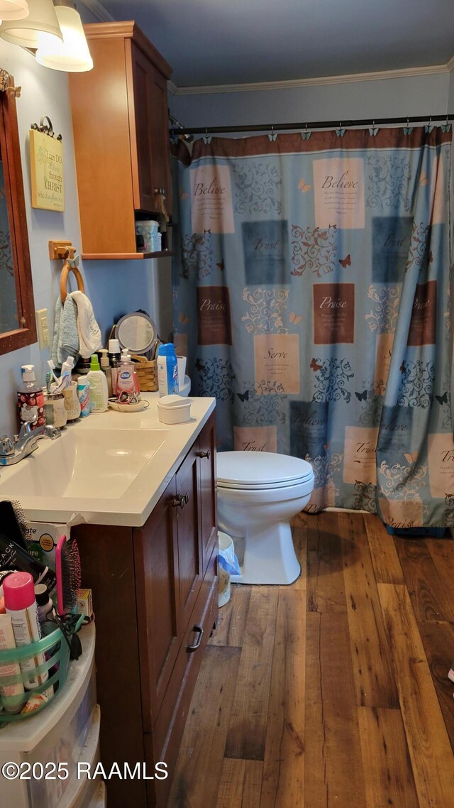 205 F St, Duson, LA 70529 - full bathroom featuring a shower with curtain, crown molding, vanity, wood-type flooring, and toilet
